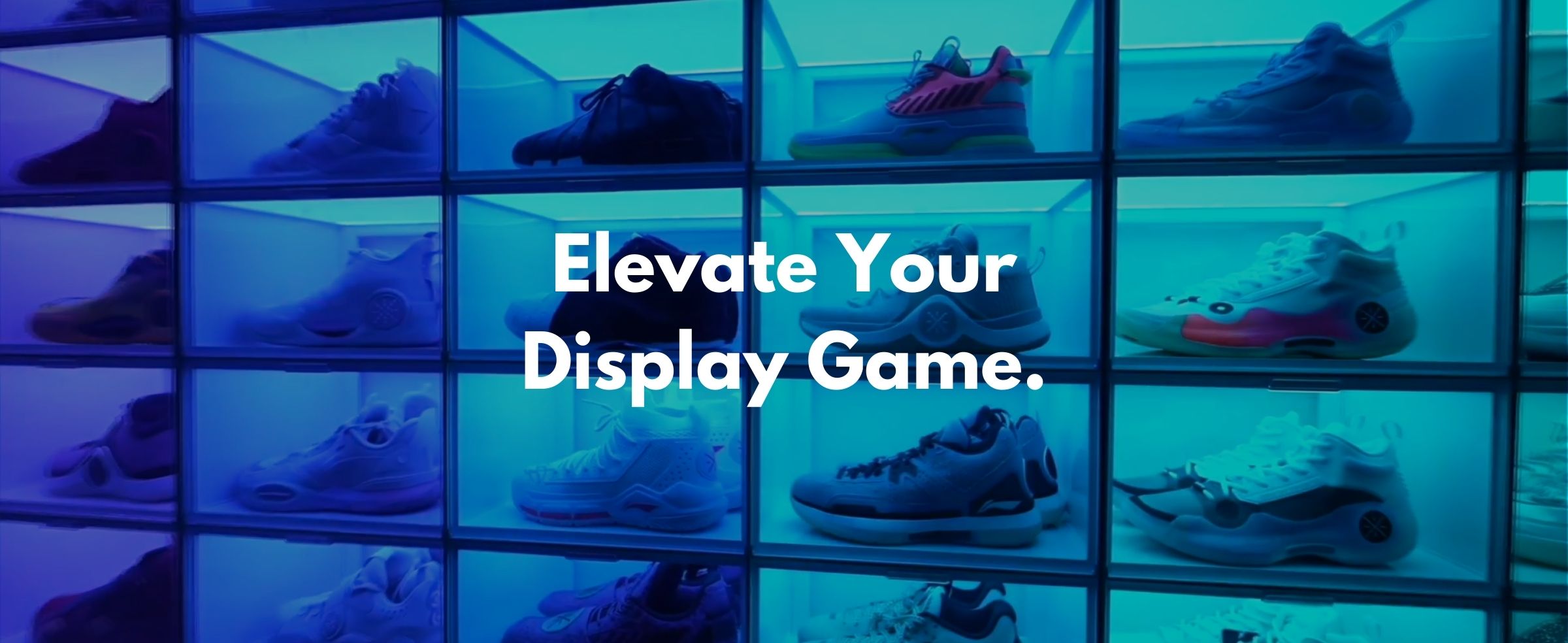 A vibrant sneaker display with illuminated shelves showcasing various athletic shoes under blue lighting, enhancing the modern look.