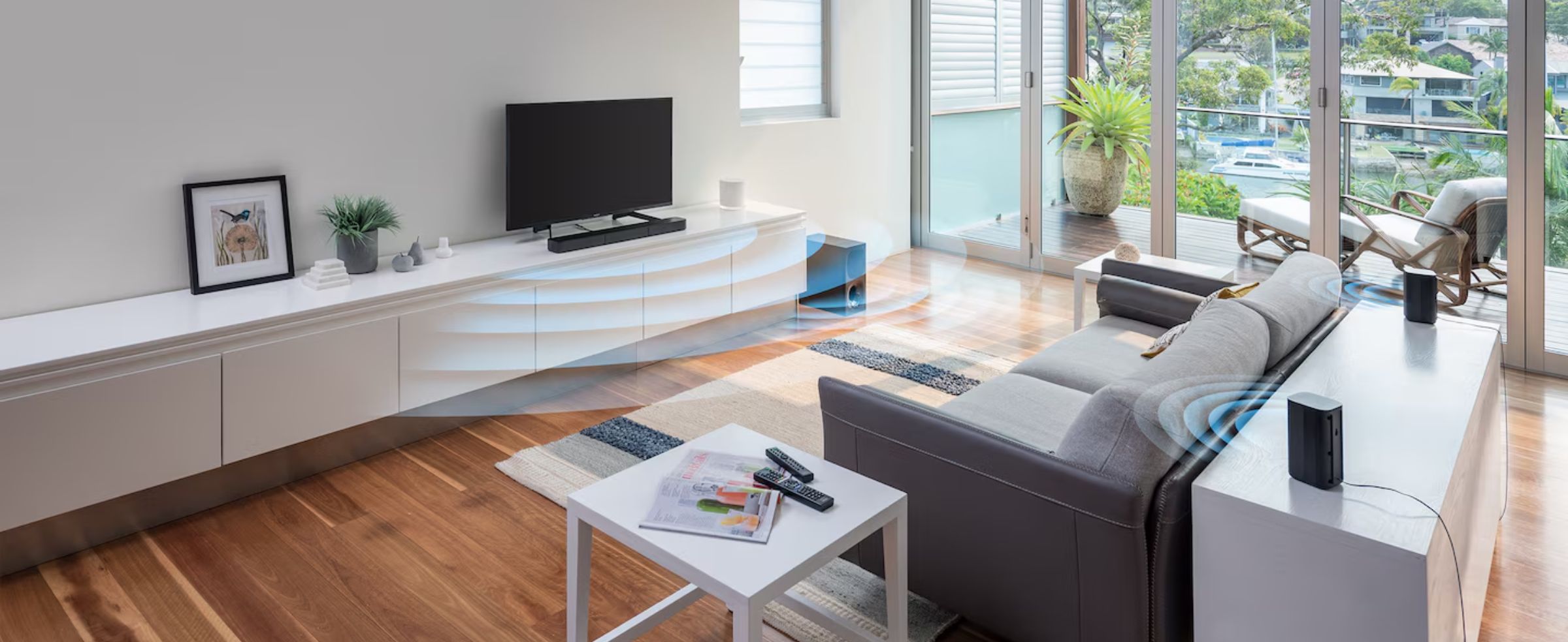 A soundbar with wireless rear speakers creates surround sound in a living room.